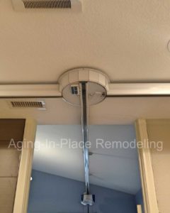 Patient ceiling lift transfers to tile barrier free shower, wall mounted toilet and walk-in tub for complete wheelchair accessibility