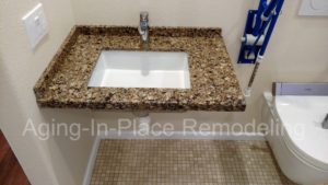 Custom countertop wheelchair accessible roll under sink for fully accessible bathroom.