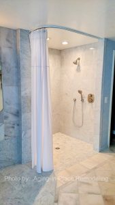 Custom Tile barrier free, roll-in shower with hand held shower head allows for wheelchair accessibility