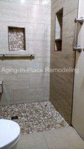 tile barrier free shower with built in shower seat for wheelchair accessibility, with grab bars for added safety